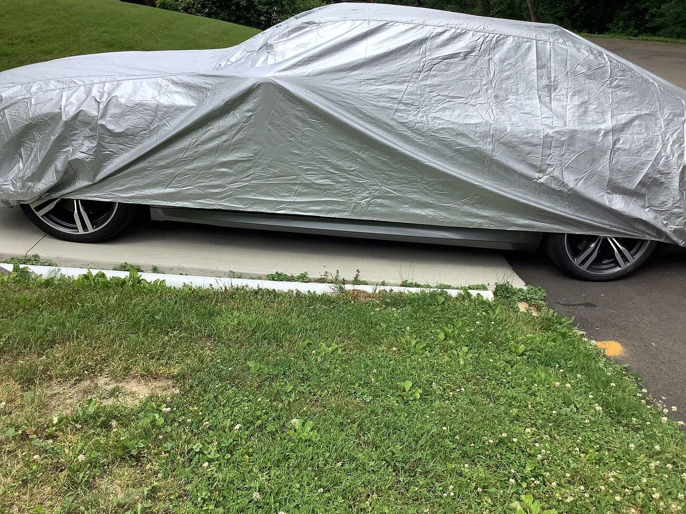 A customer's car under its CarCovers cover