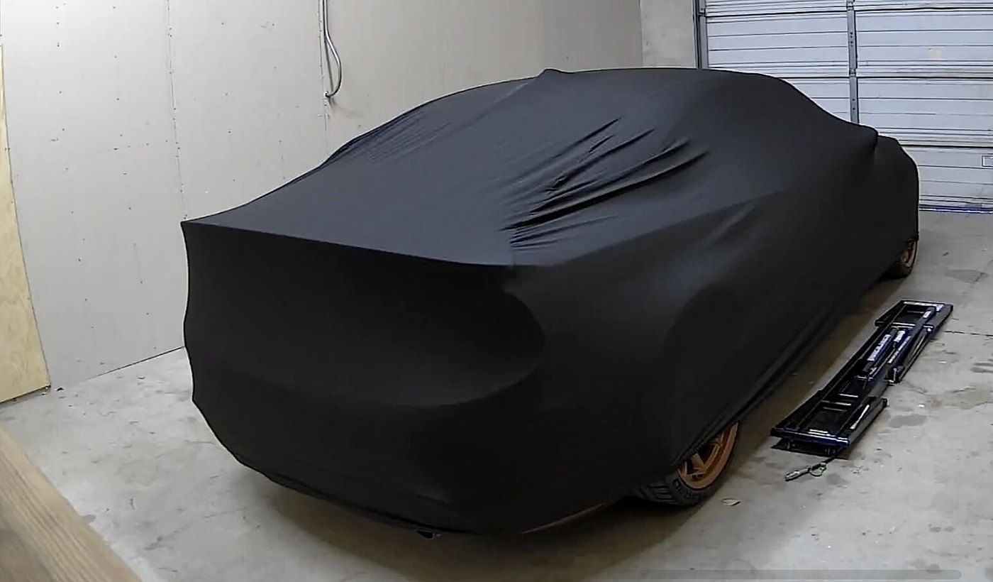 A customer's garage-kept car under its CarCovers cover