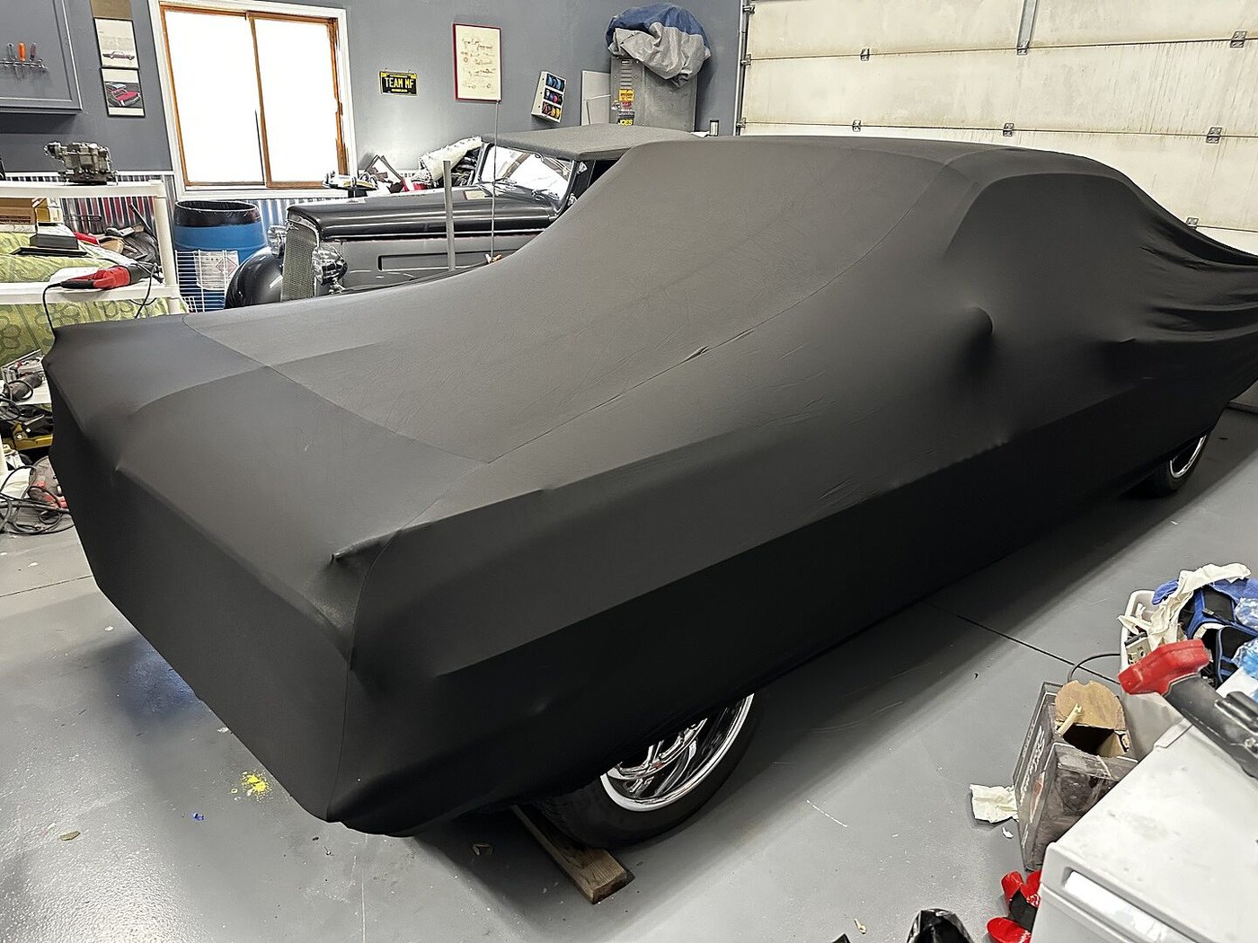 A customer's garage-kept car under its CarCovers cover