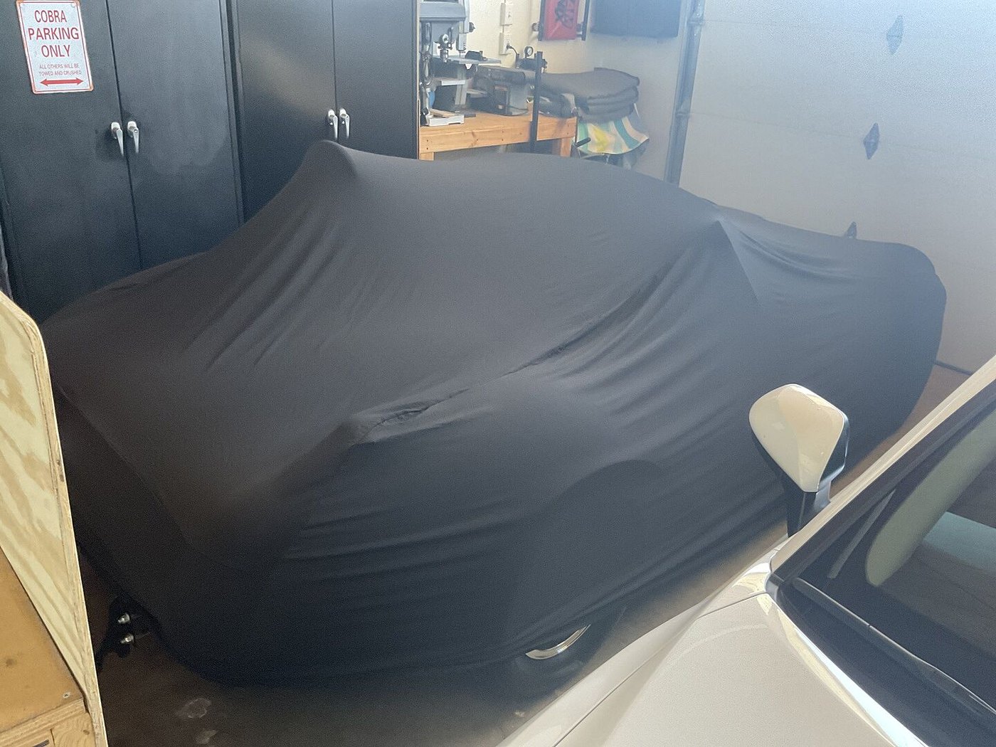 A customer's garage-kept car under its CarCovers cover