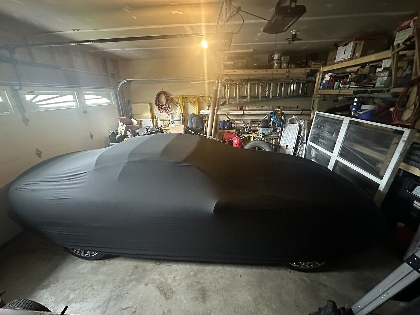 A customer's garage-kept car under its CarCovers cover