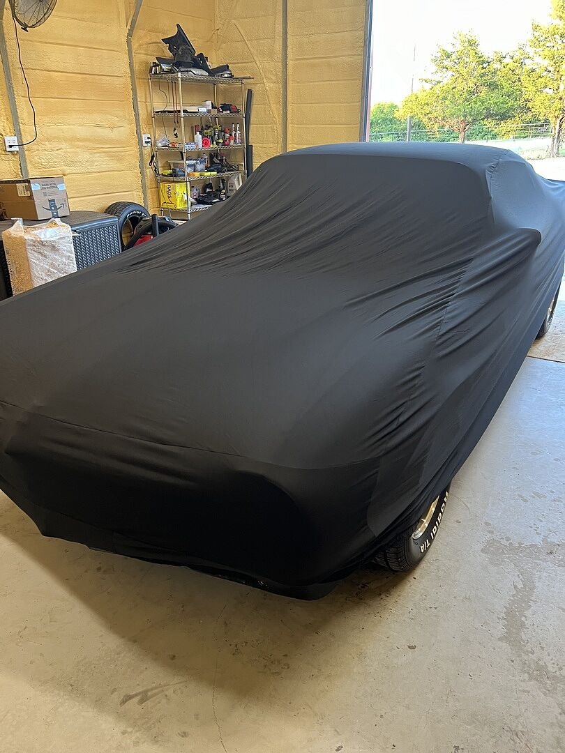 A customer's garage-kept car under its CarCovers cover